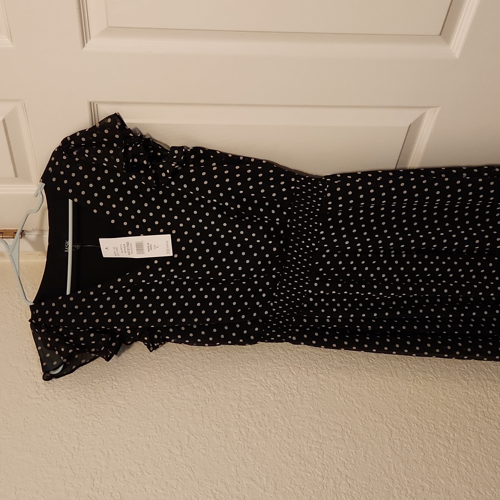 Women's black dress with tan polka dots.